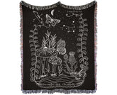 Sagittarius woven blanket featuring intricate designs of mushrooms, butterflies, and stars with colorful fringed edges.